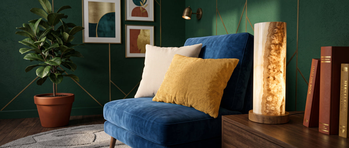 Cosy reading nook with a Petrona lamp, decorative cushions in Poso and Sorriso fabrics and a navy armchair