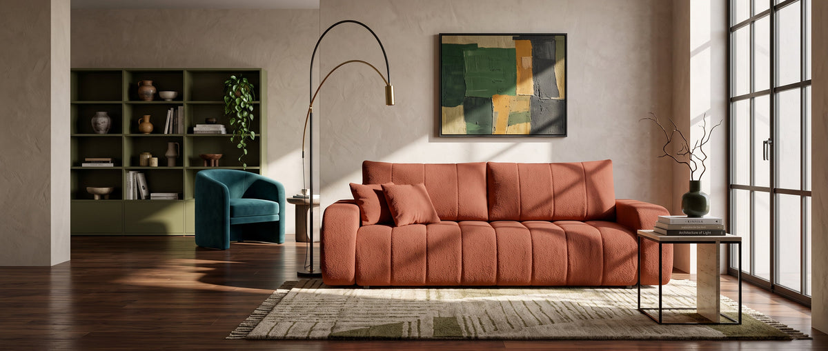 Modern living room with a terracotta Baloa sofa, designer lighting, a bookcase and large windows letting in natural light