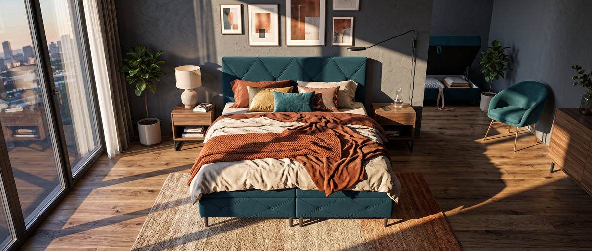 Cosy bedroom with a turquoise Wianec divan bed, decorative cushions and large windows letting in natural light