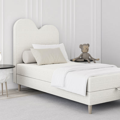 Mellia Kids Continental Divan Bed with a Wavy Headboard and Storage 90x160 and 90x180, Soft Modern Style – in a room setting