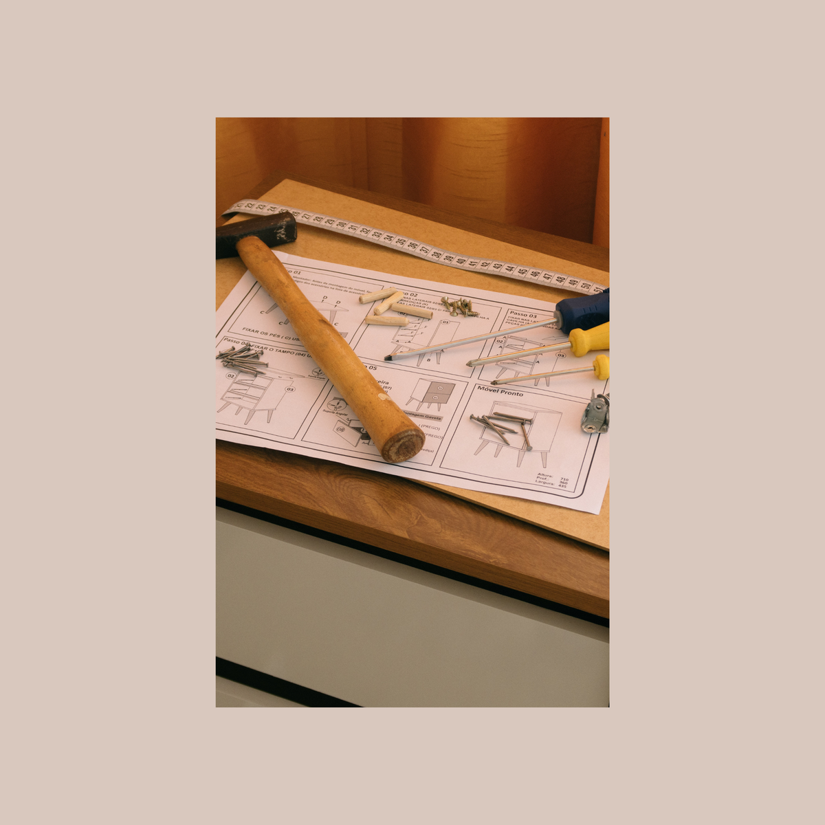Tools and assembly instructions on a furniture panel
