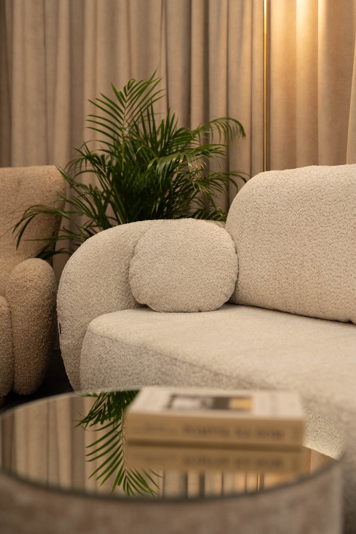 Detail of the Olemo sofa in light bouclé fabric.